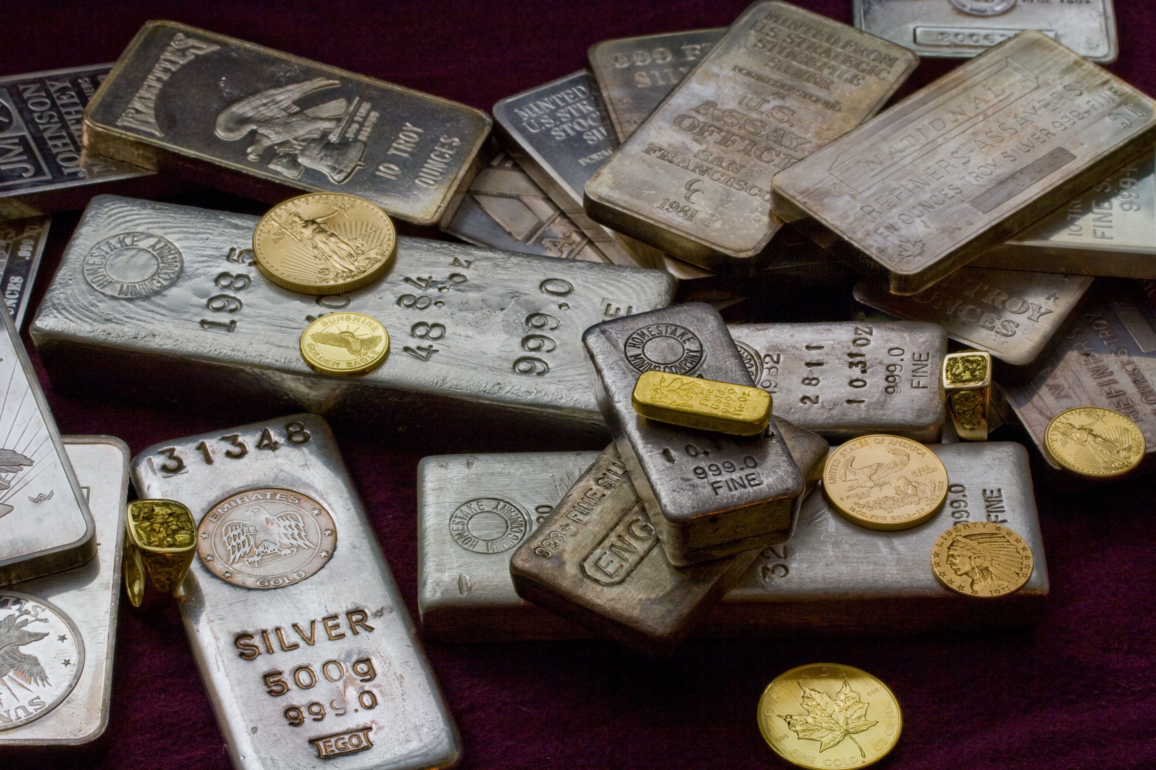 Gold and silver bars with U.S. coins — trusted local gold buyer in Arkansas