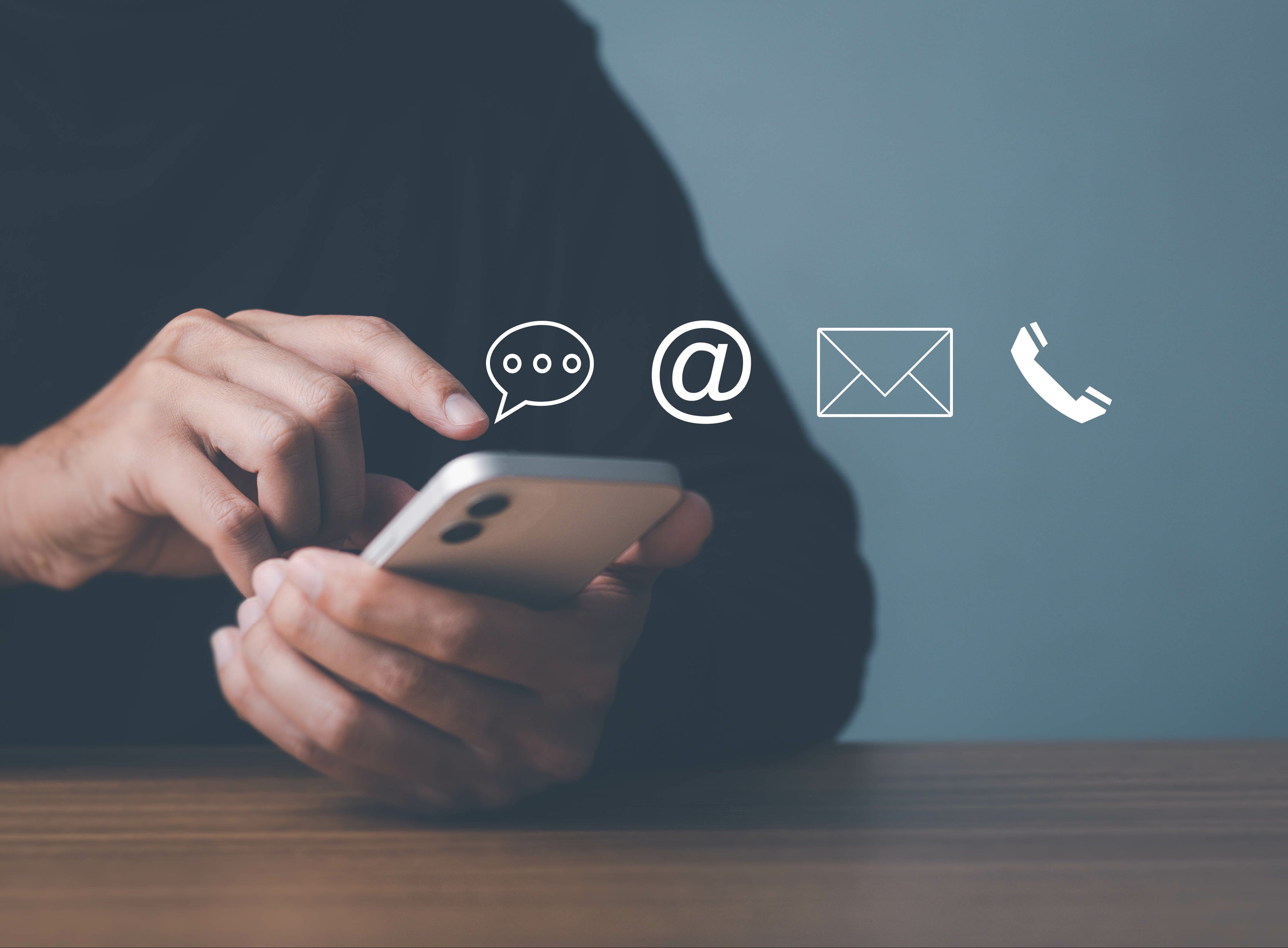 Hand holding phone with message icons — first step to sell gold in Arkansas